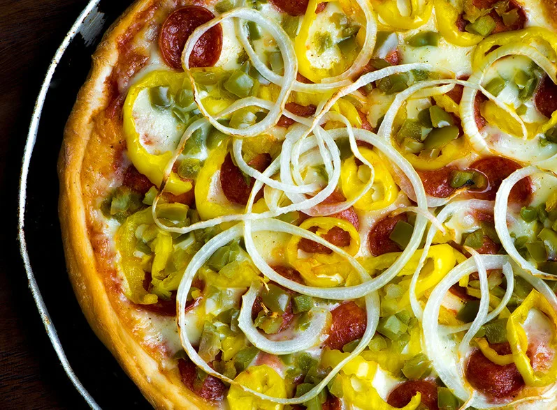 close up image of a deluxe pizza